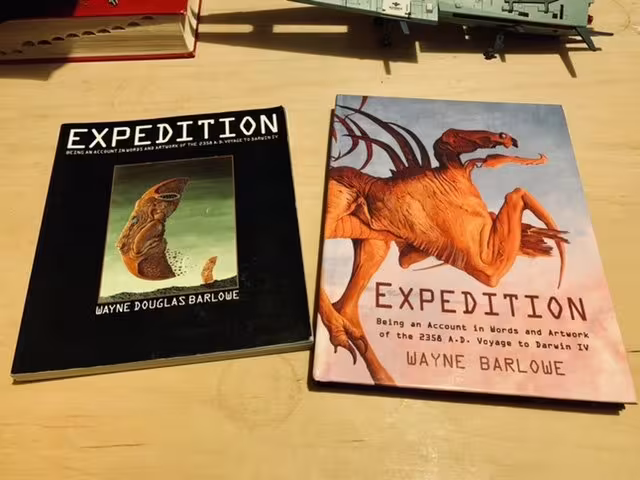 Two different editions of the Expedition book on a library table.