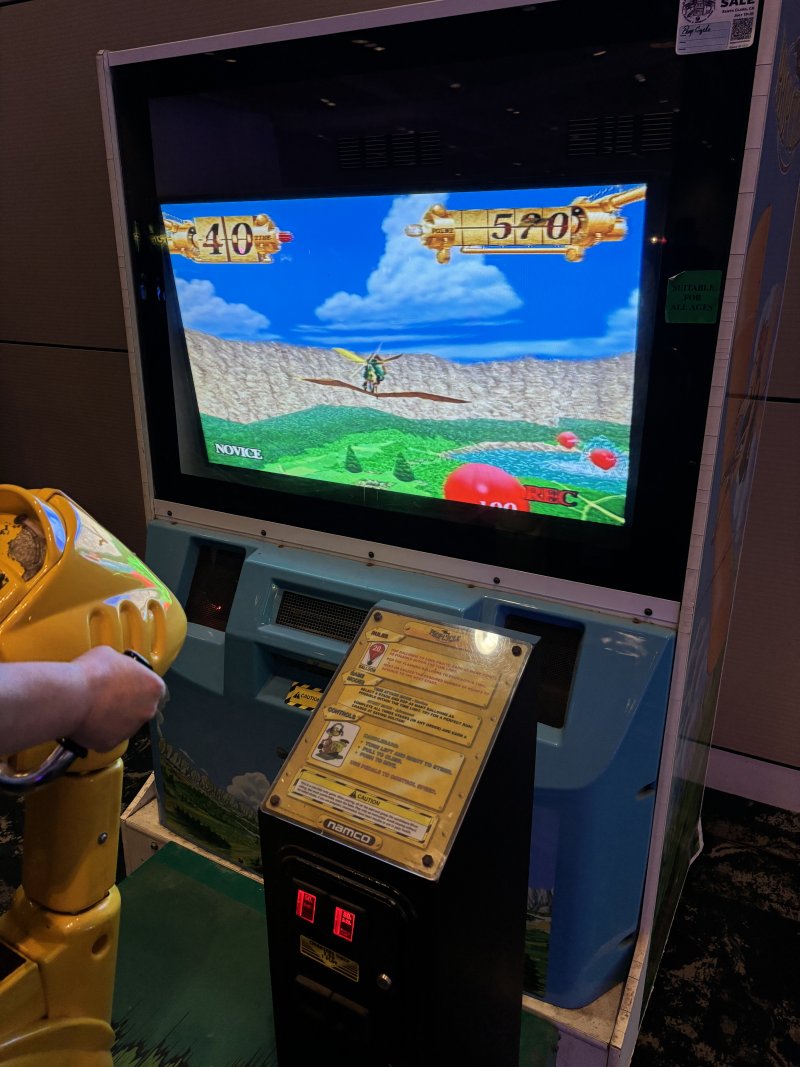 Namco's Propcycle cabinet, with a controller which must be sat in like a bicycle in front of a screen.